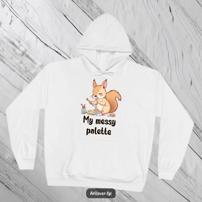 Funny hoodie showcasing an enthusiastic squirrel mixing paints with a tiny twig, embodying playful artistic energy.